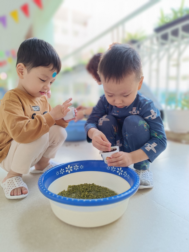 Two young boys playing with food

Description automatically generated